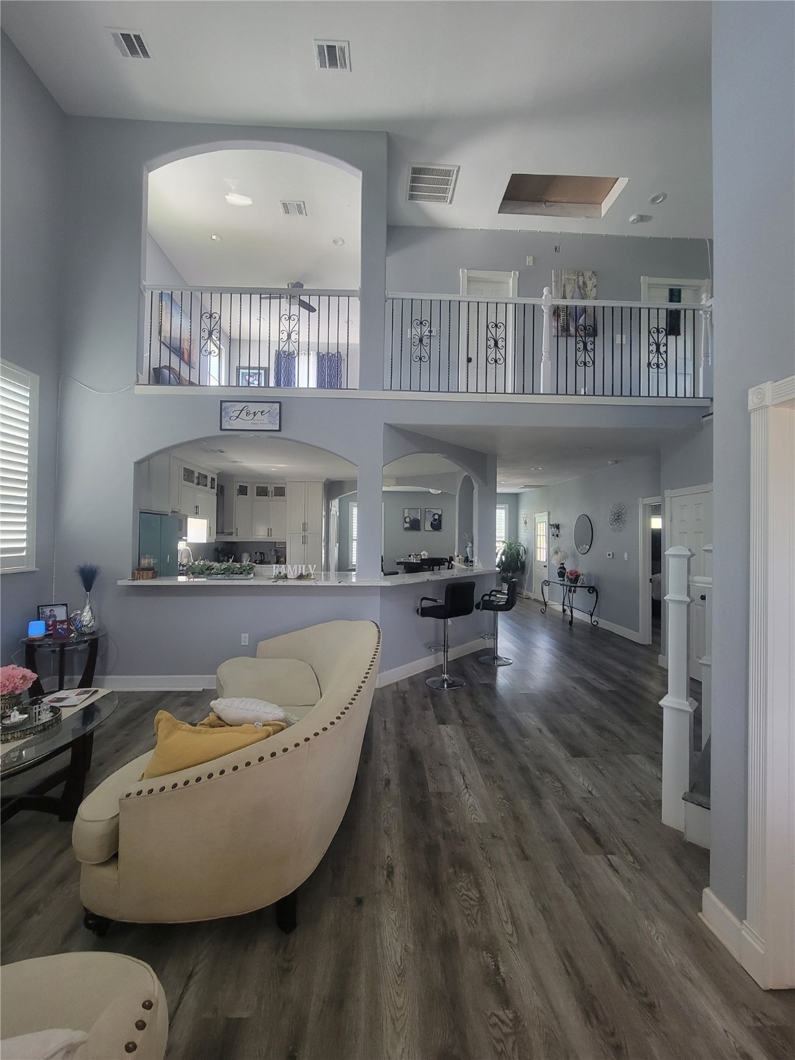 a living room with furniture and a chandelier