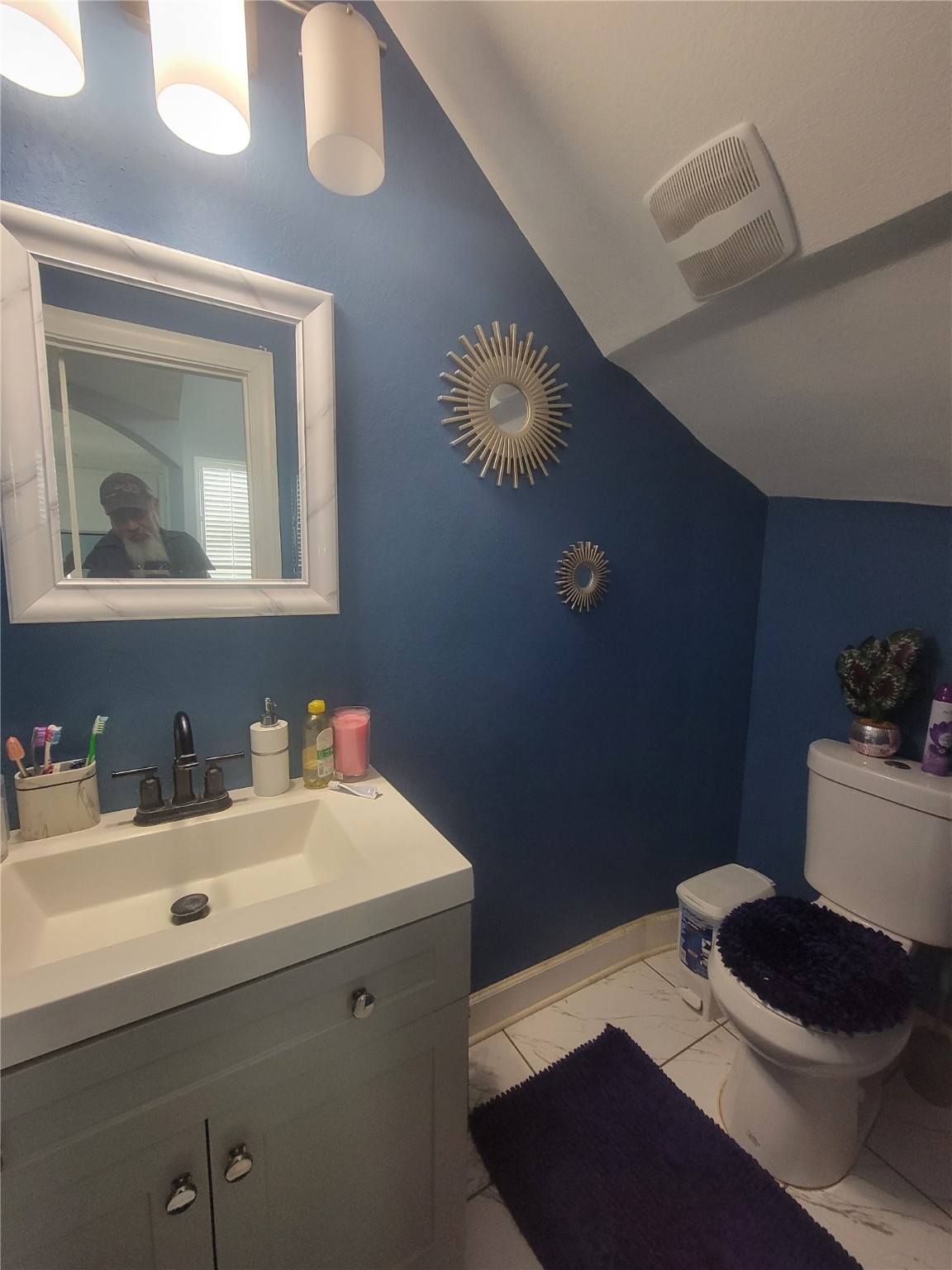 248 County Road 3572 Cleveland, TX 77327 - Photo 12 of 29 a bathroom with a sink a toilet and a mirror