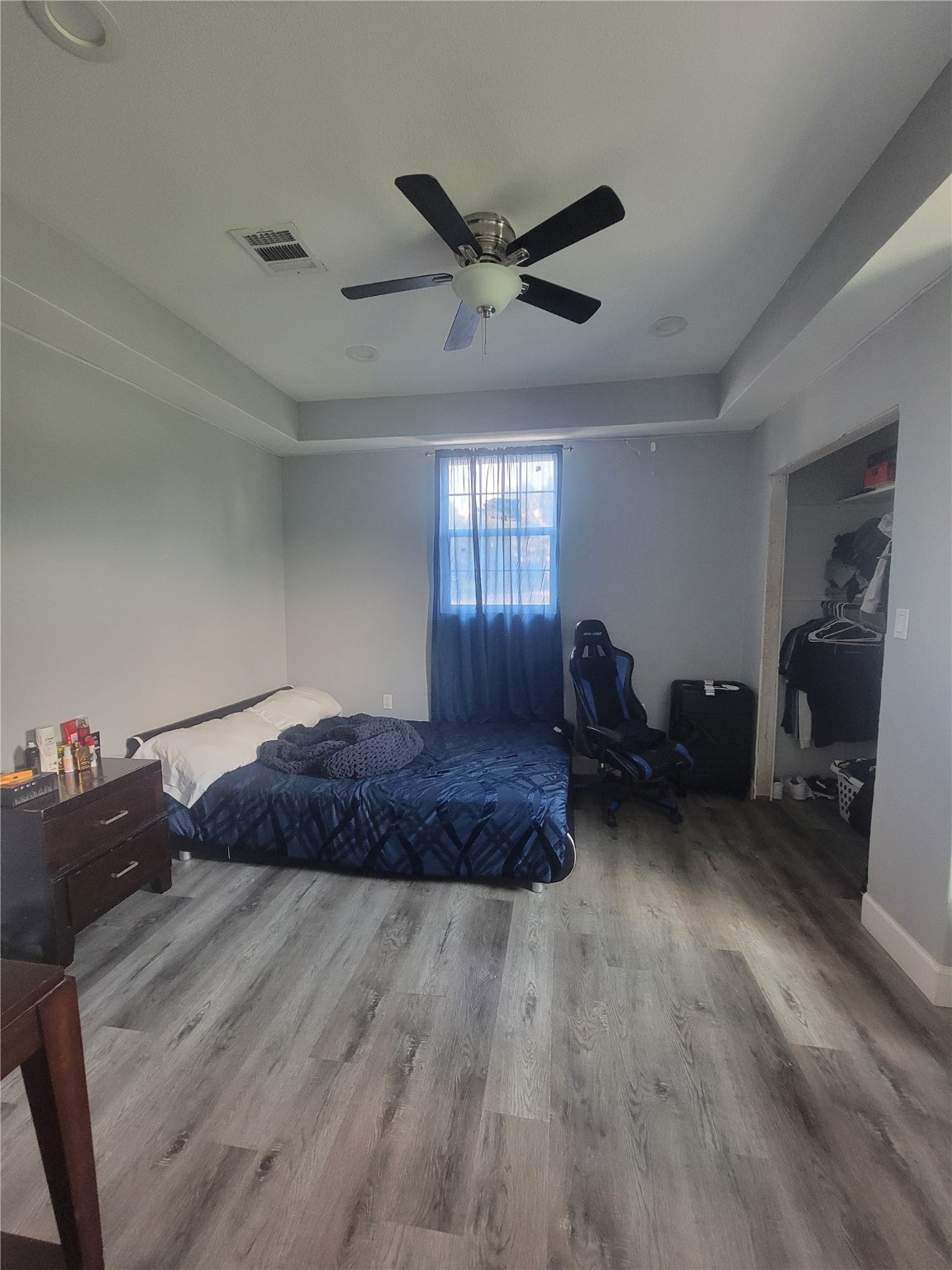 248 County Road 3572 Cleveland, TX 77327 - Photo 18 of 29 a spacious bedroom with a bed and a chandelier