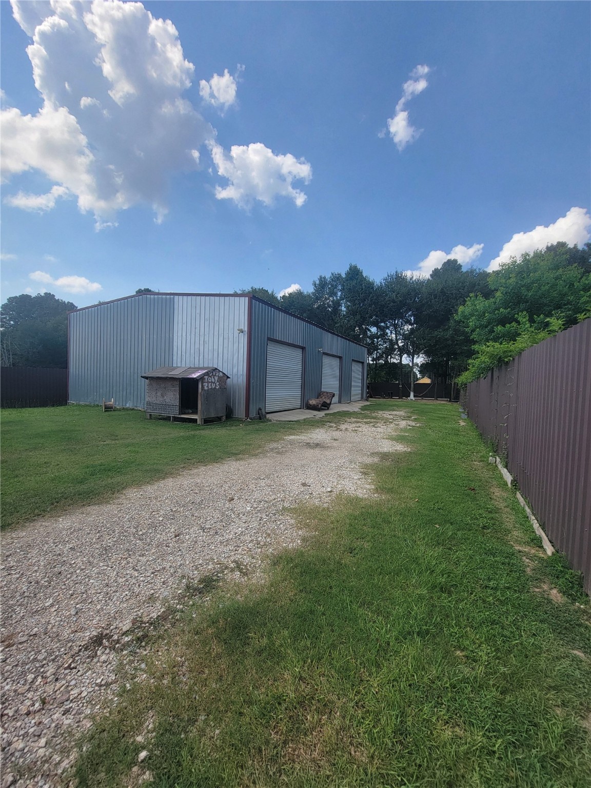 248 County Road 3572 Cleveland, TX 77327 - Photo 24 of 29 a view of a house with a yard