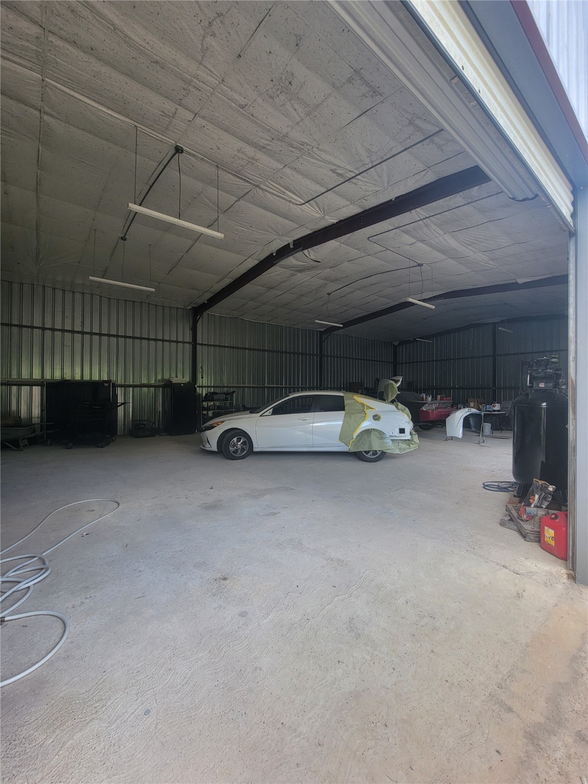 248 County Road 3572 Cleveland, TX 77327 - Photo 25 of 29 a view of parking garage with cars