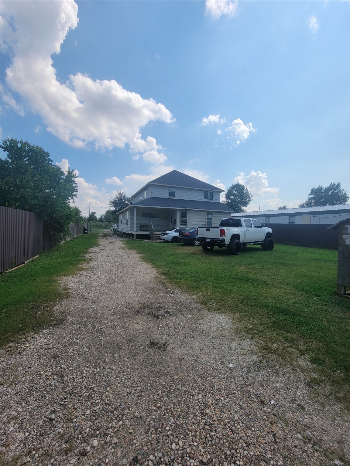 248 County Road 3572 Cleveland, TX 77327 - Photo 28 of 29 a view of a yard with a house in the background