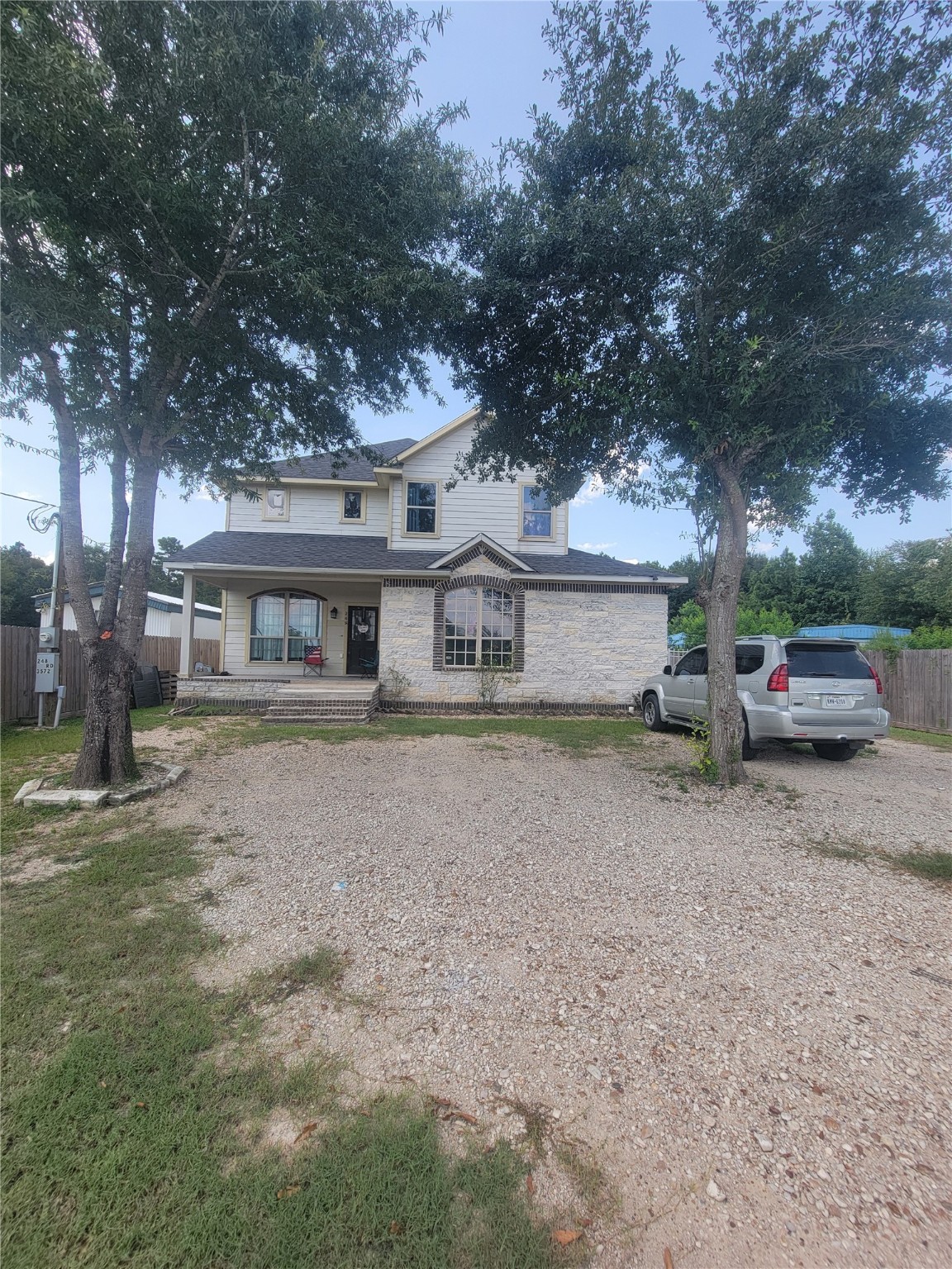 248 County Road 3572 Cleveland, TX 77327 - Photo 3 of 29 a front view of a house with a yard