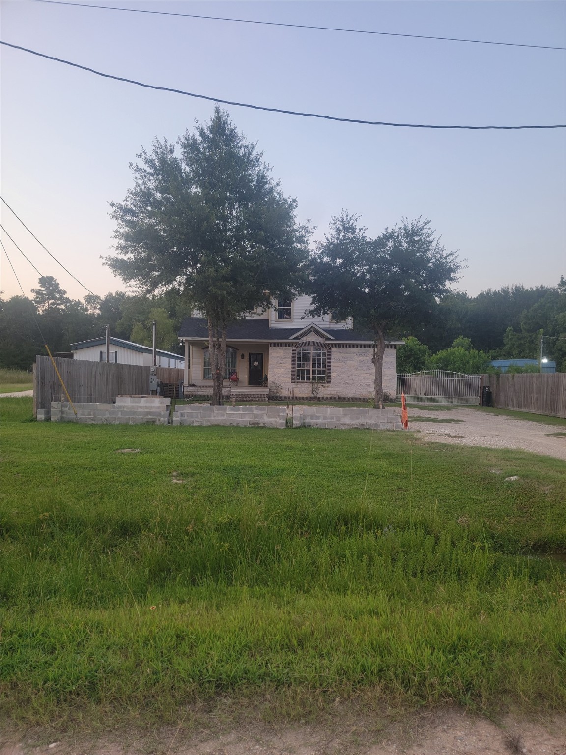 248 County Road 3572 Cleveland, TX 77327 - Photo 4 of 29 a view of a house with a backyard