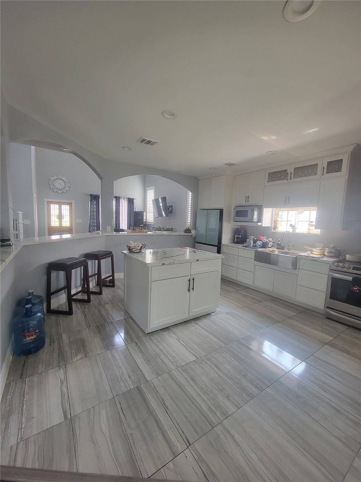 248 County Road 3572 Cleveland, TX 77327 - Photo 7 of 29 a large kitchen with wooden floors and wooden cabinets
