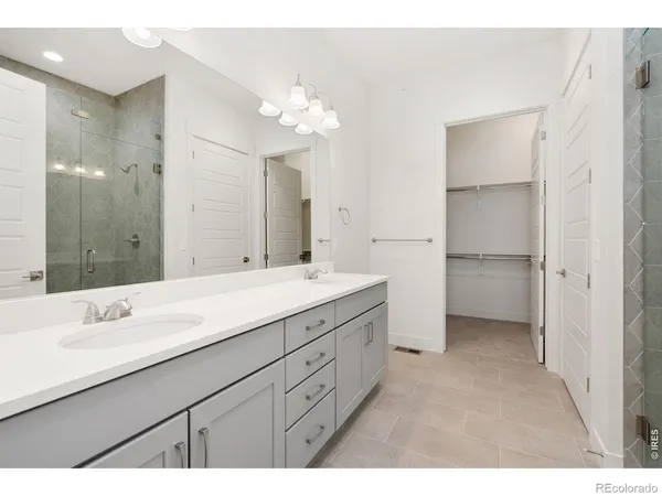 a bathroom with a double vanity sink and a mirror