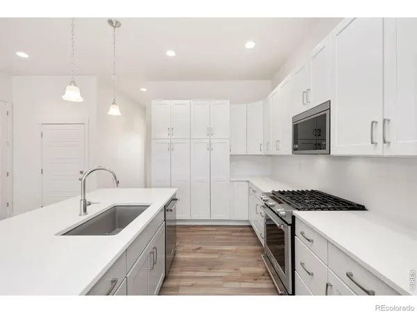 a kitchen that has a sink and a stove