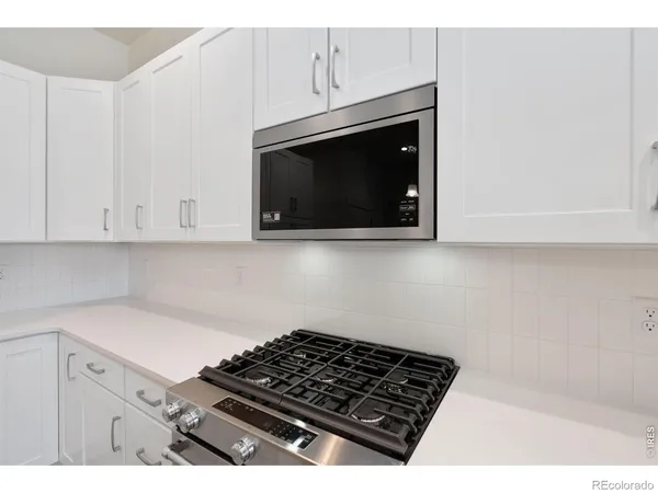 a stove top oven sitting inside of a kitchen