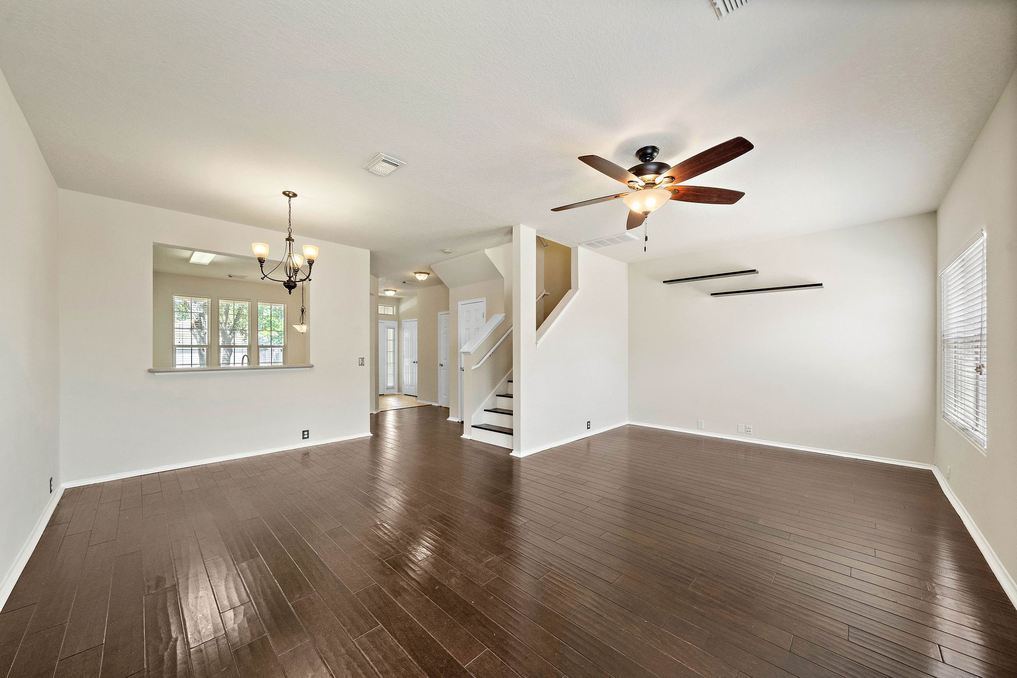 3508 Glenmore Meadow Drive Spring, TX 77386 - Photo 13 of 13 an empty room with wooden floor chandelier fan and windows