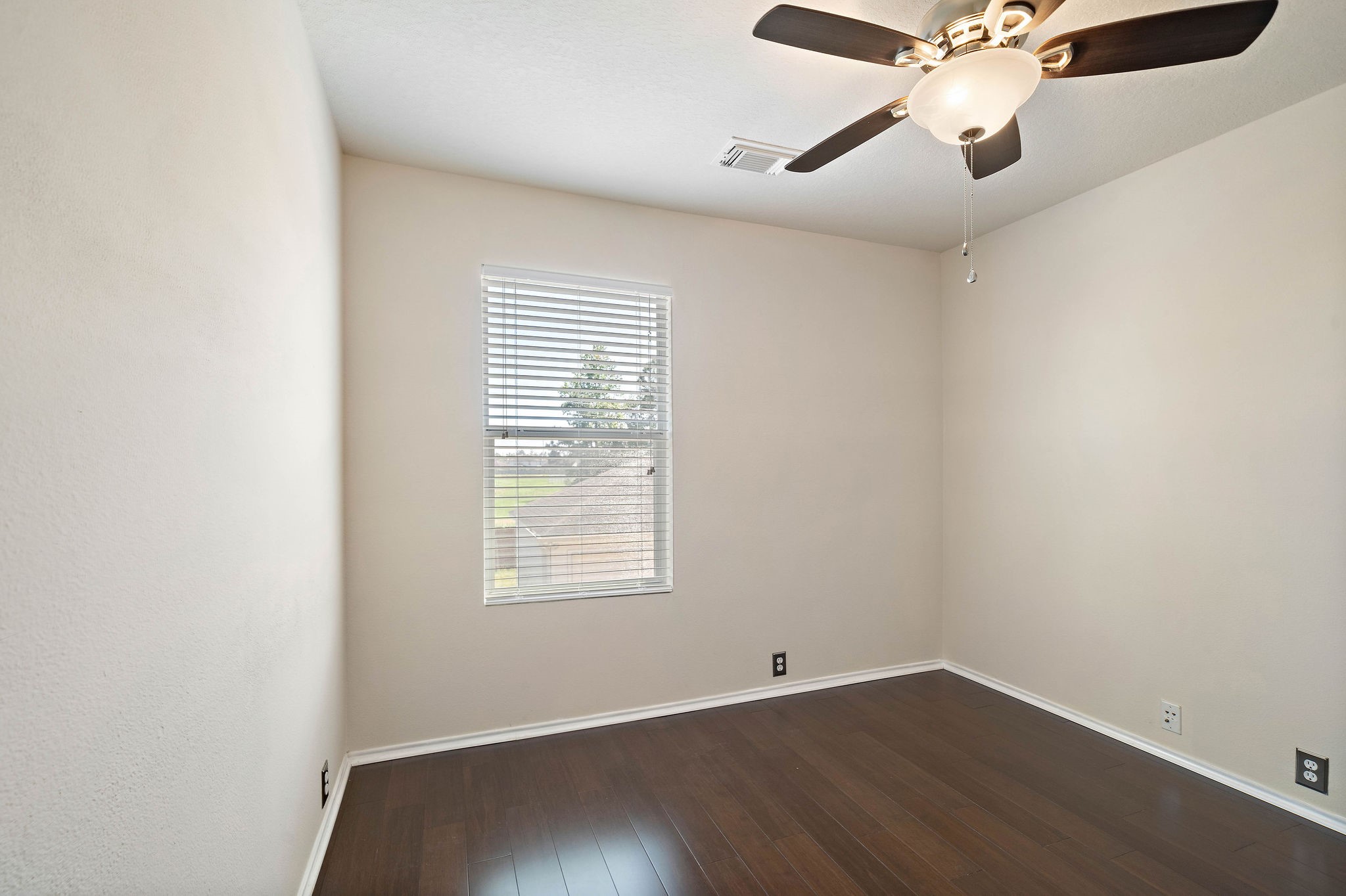 3508 Glenmore Meadow Drive Spring, TX 77386 - Photo 6 of 13 an empty room with wooden floor fan and windows