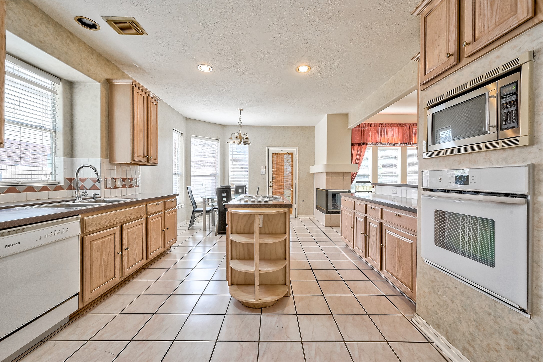 6806 Rhodes Court Missouri City, TX 77459 - Photo 16 of 50 a kitchen with stainless steel appliances a stove sink cabinets and microwave