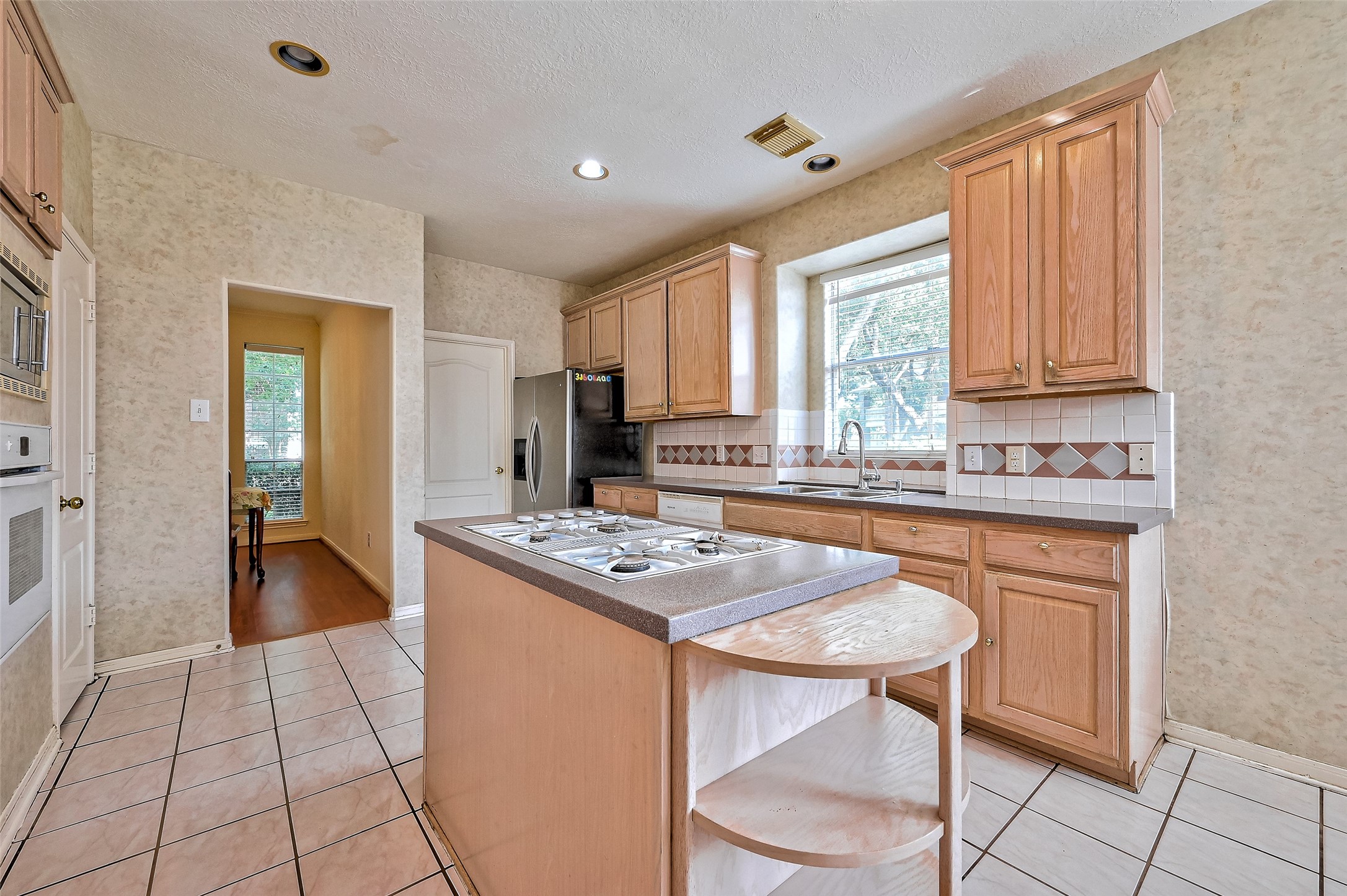 6806 Rhodes Court Missouri City, TX 77459 - Photo 21 of 50 a kitchen with stainless steel appliances granite countertop a stove a sink dishwasher and a refrigerator