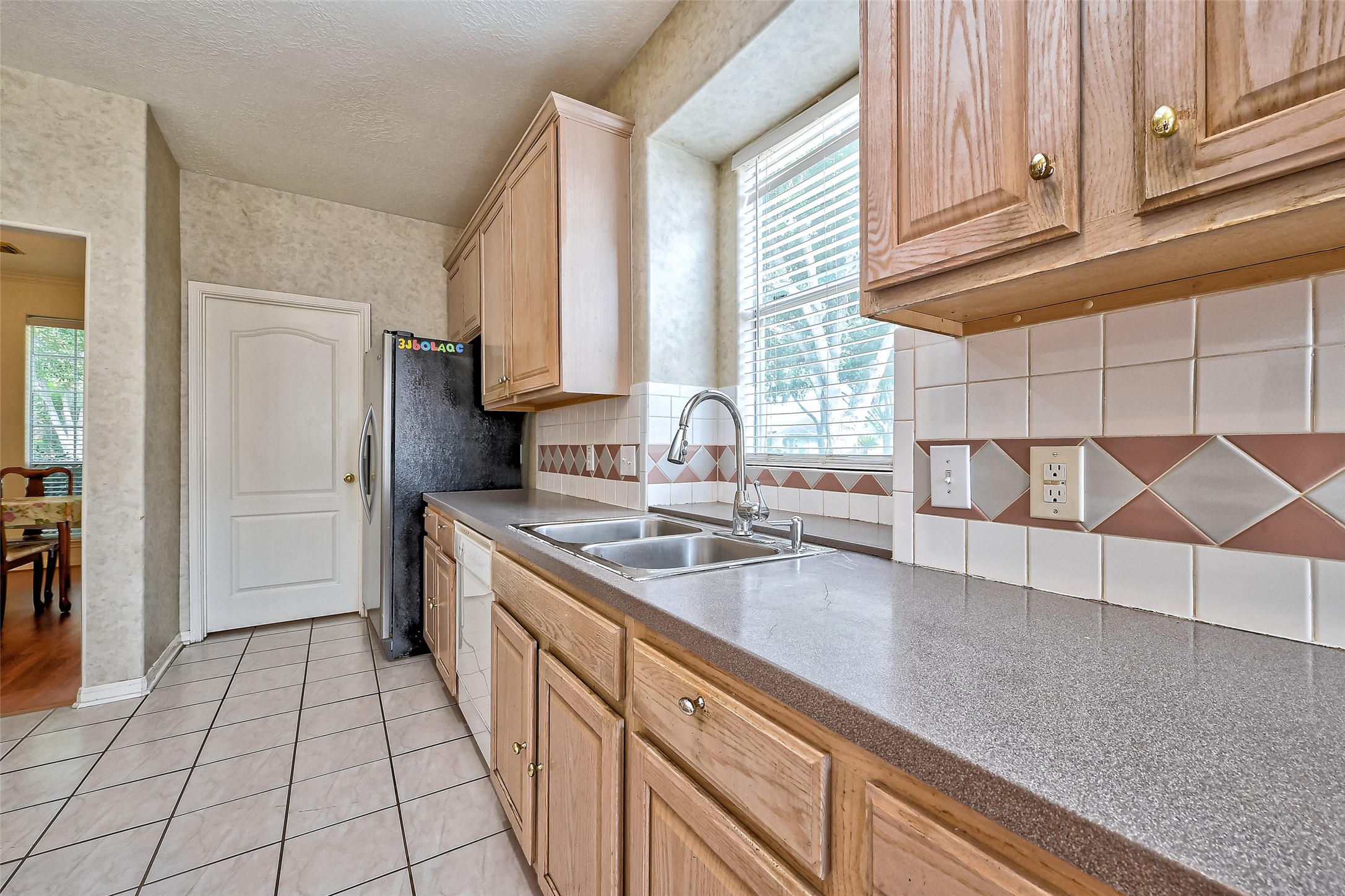 6806 Rhodes Court Missouri City, TX 77459 - Photo 23 of 50 a kitchen with a sink and cabinets