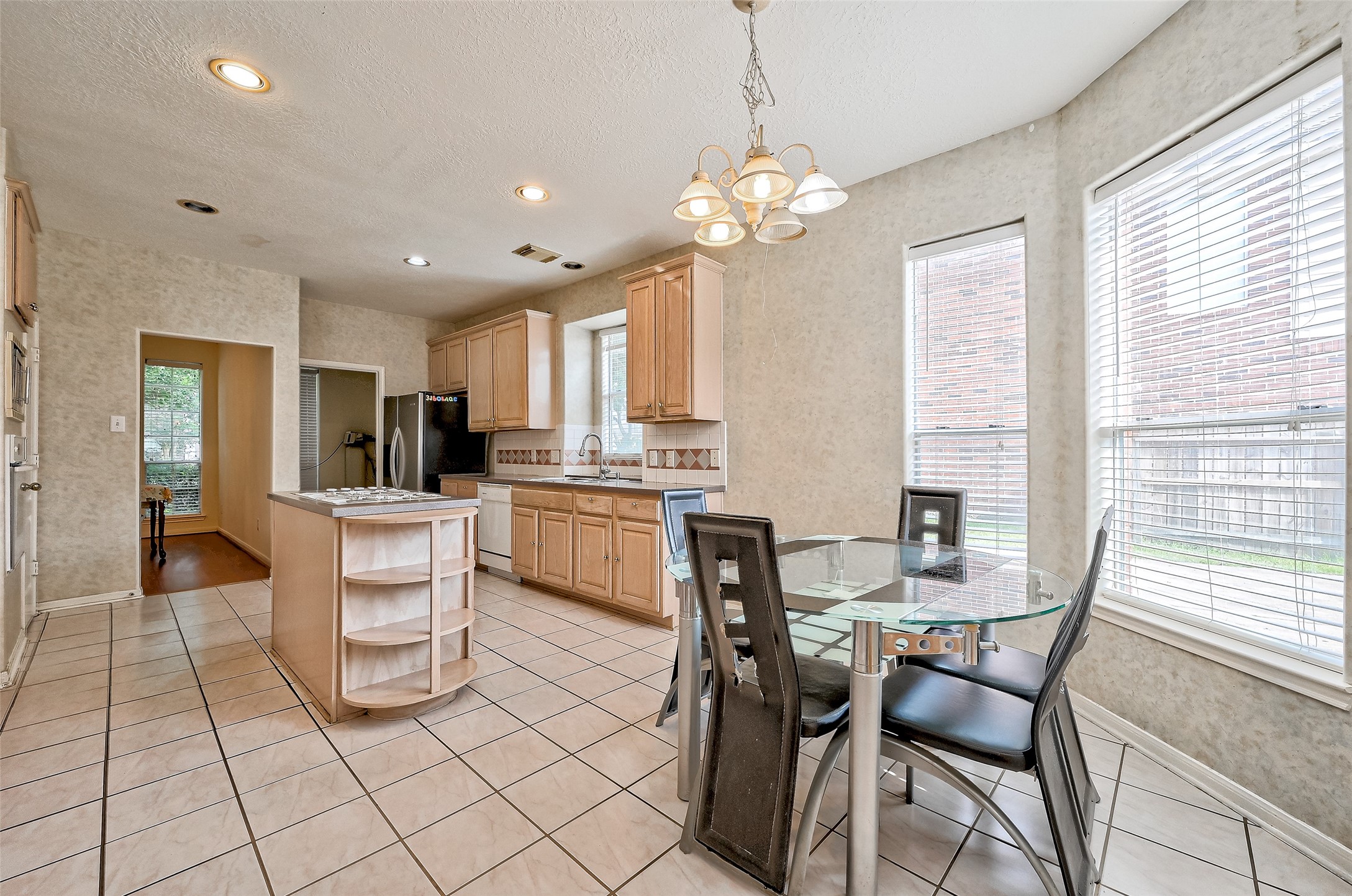 6806 Rhodes Court Missouri City, TX 77459 - Photo 25 of 50 a view of kitchen with refrigerator dining table and chairs