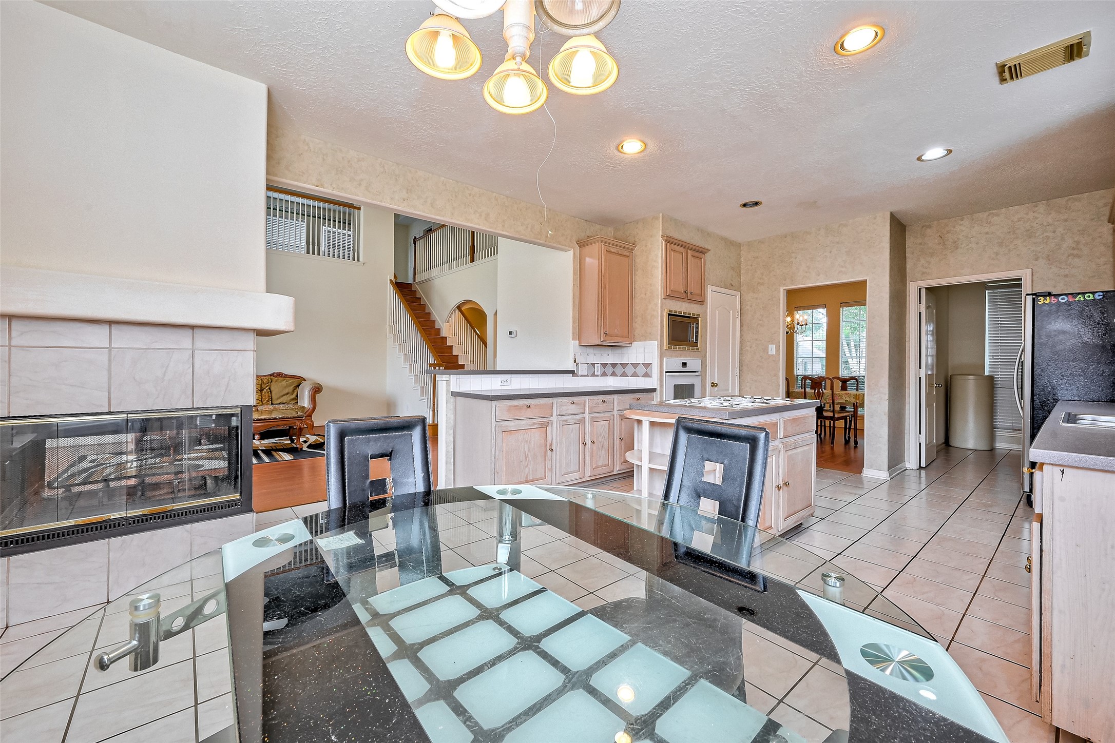6806 Rhodes Court Missouri City, TX 77459 - Photo 26 of 50 a living room with furniture a dining table and chairs