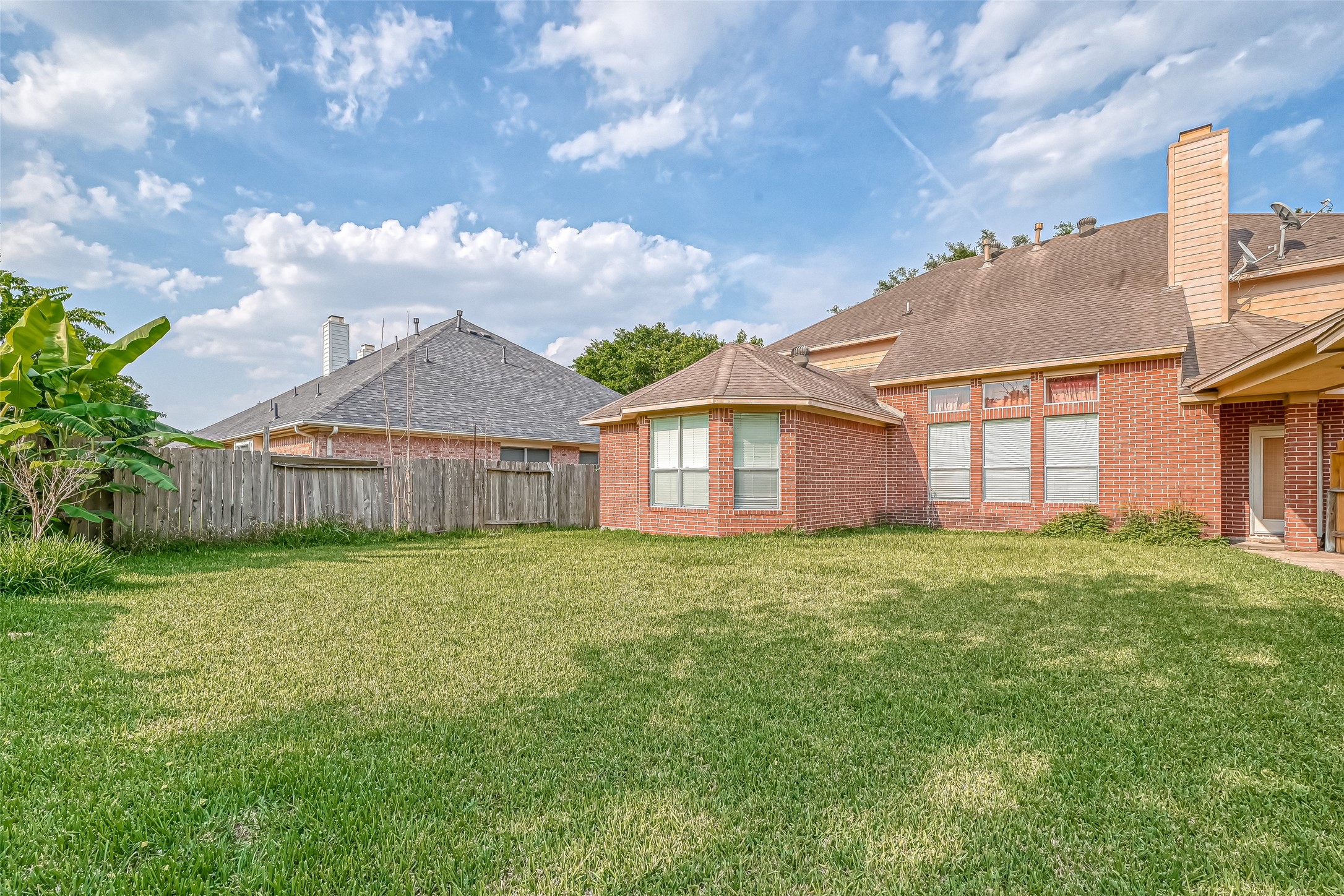 6806 Rhodes Court Missouri City, TX 77459 - Photo 49 of 50 a view of a yard in front of a house with large trees