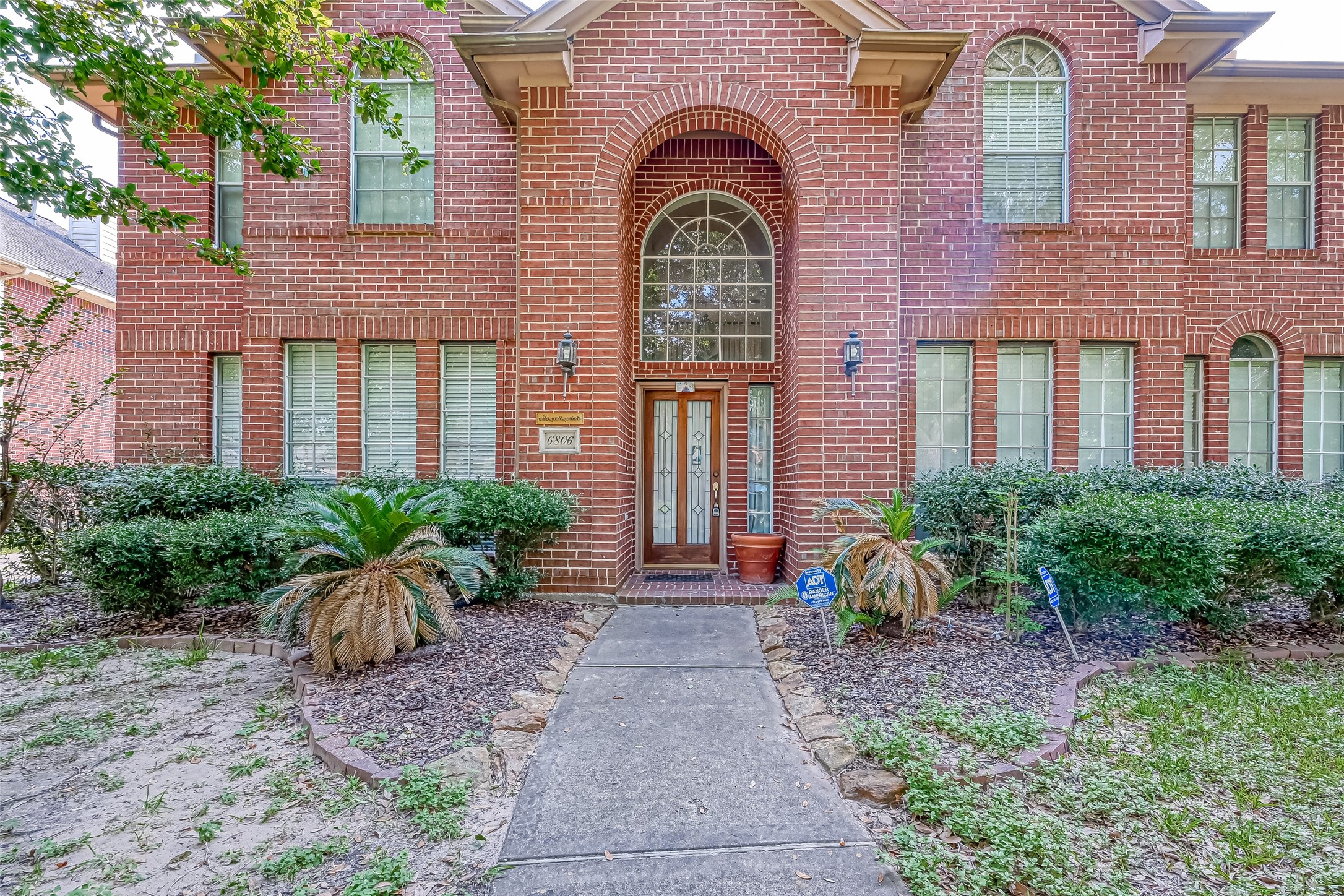 6806 Rhodes Court Missouri City, TX 77459 - Photo 5 of 50 a front view of a house with garden and plants
