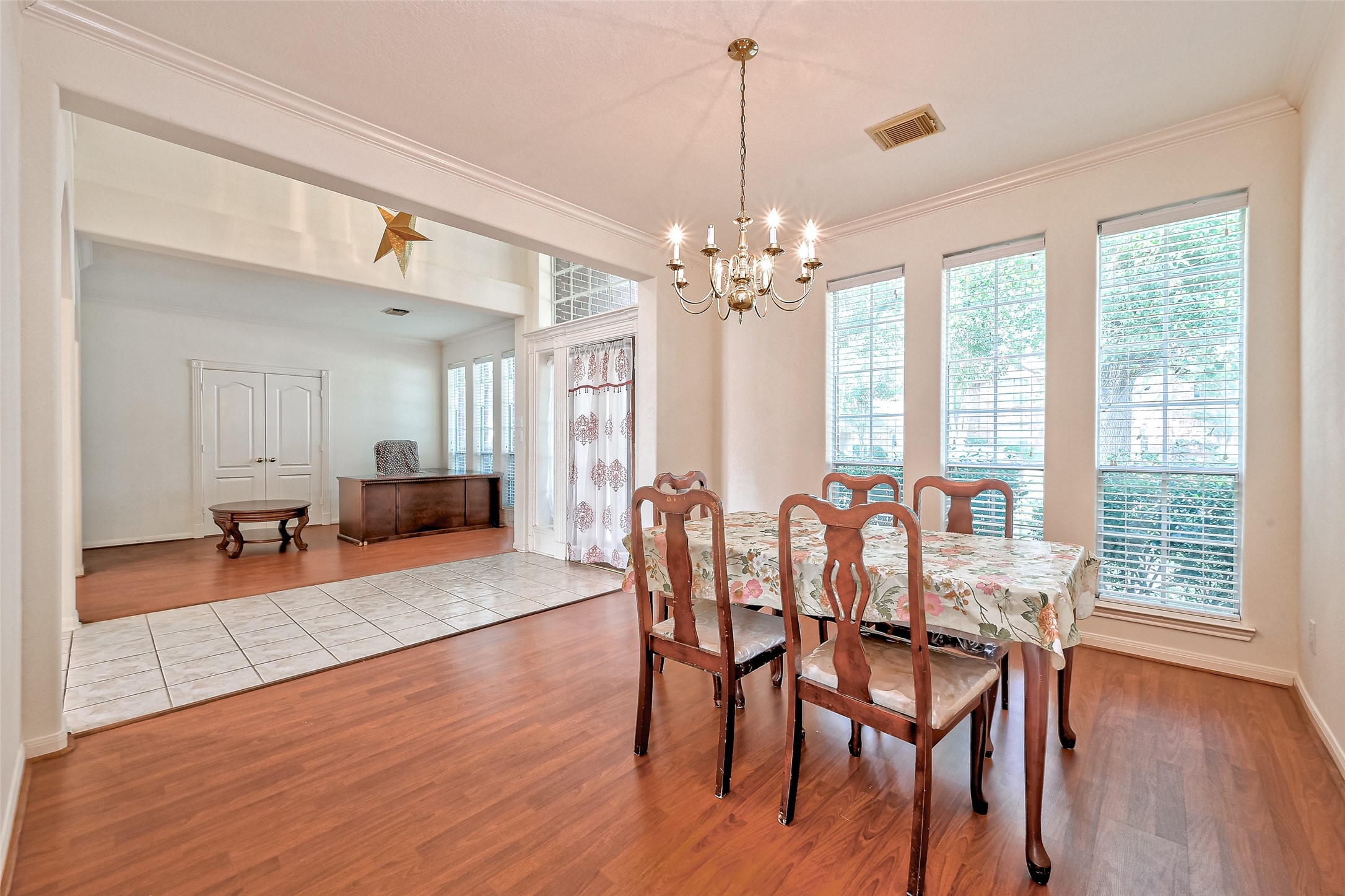 6806 Rhodes Court Missouri City, TX 77459 - Photo 9 of 50 a view of a dining room with furniture window and wooden floor