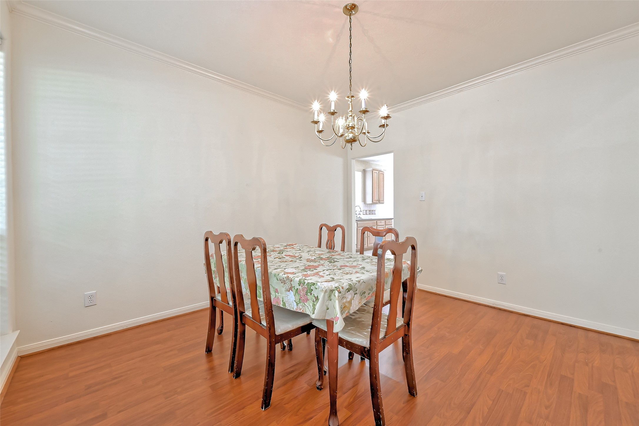 6806 Rhodes Court Missouri City, TX 77459 - Photo 10 of 50 a view of a dining room with furniture a chandelier and wooden floor