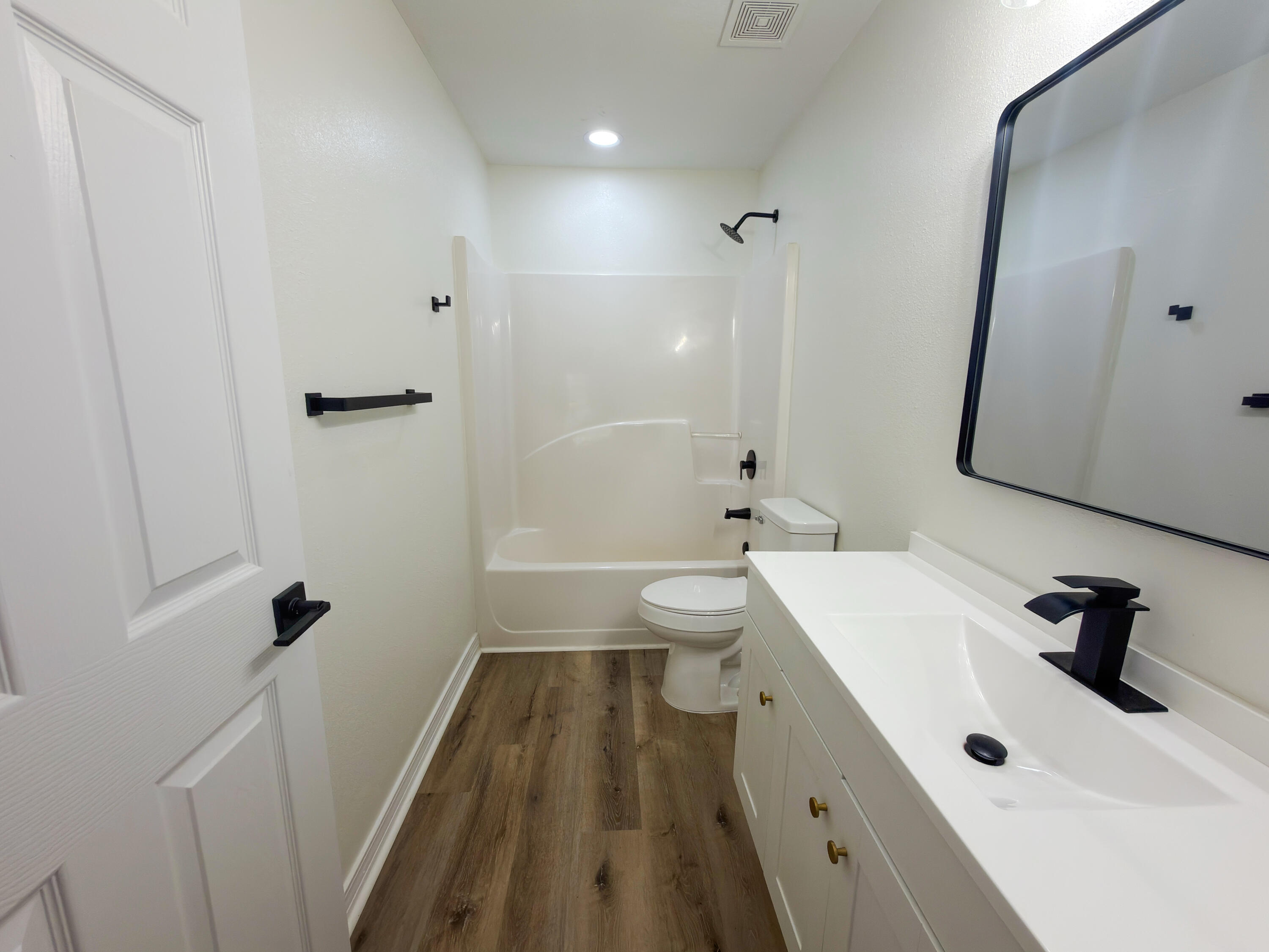 6121 Robin Road Crestview, FL 32539 - Photo 11 of 26 a bathroom with a double vanity sink a toilet and a tub