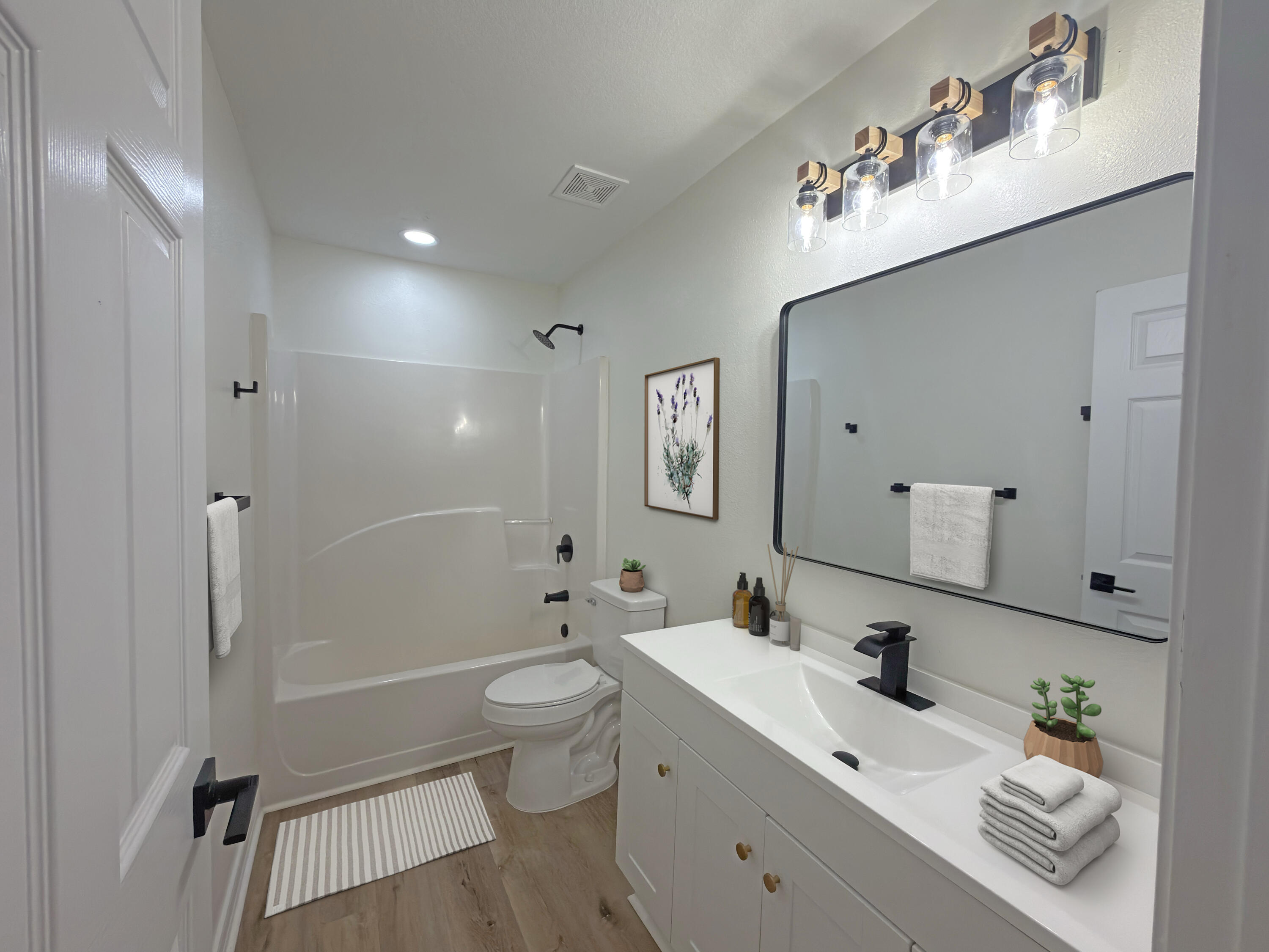 6121 Robin Road Crestview, FL 32539 - Photo 12 of 26 a bathroom with a bathtub shower sink mirror and toilet