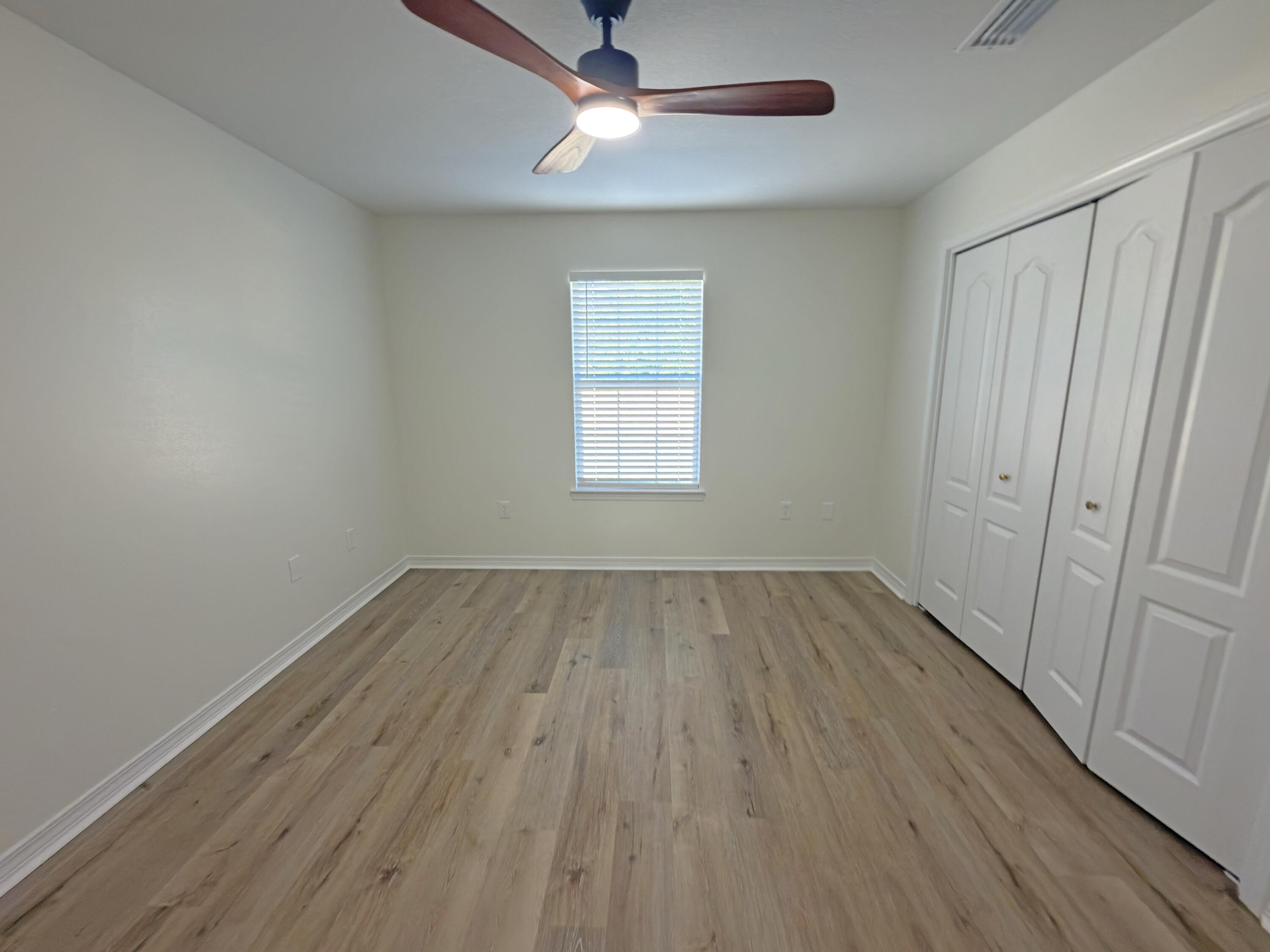 6121 Robin Road Crestview, FL 32539 - Photo 16 of 26 wooden floor in an empty room with a window
