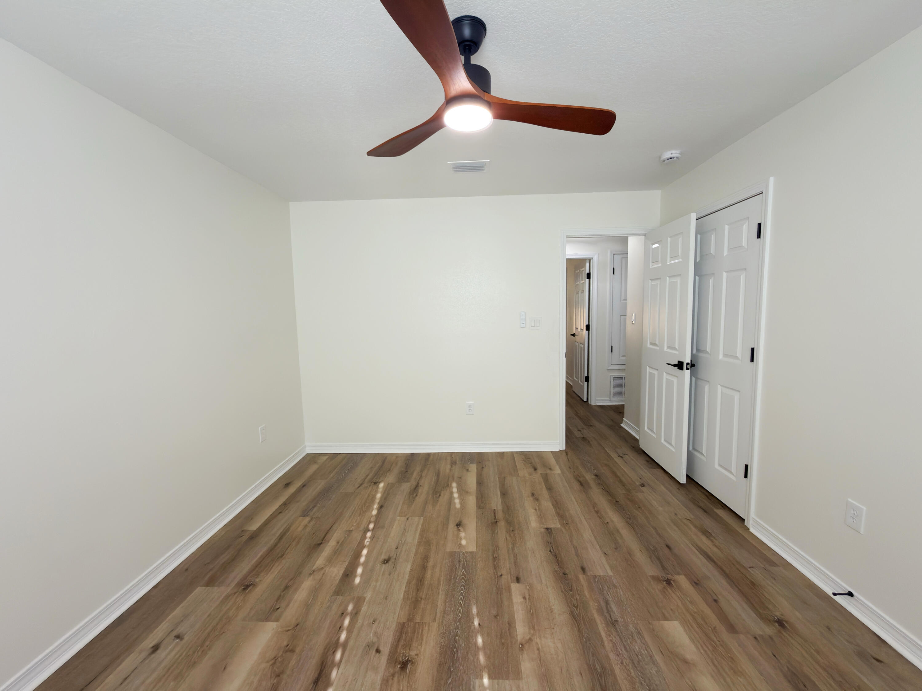 6121 Robin Road Crestview, FL 32539 - Photo 22 of 26 a view of room with wooden floor ceiling fan and window