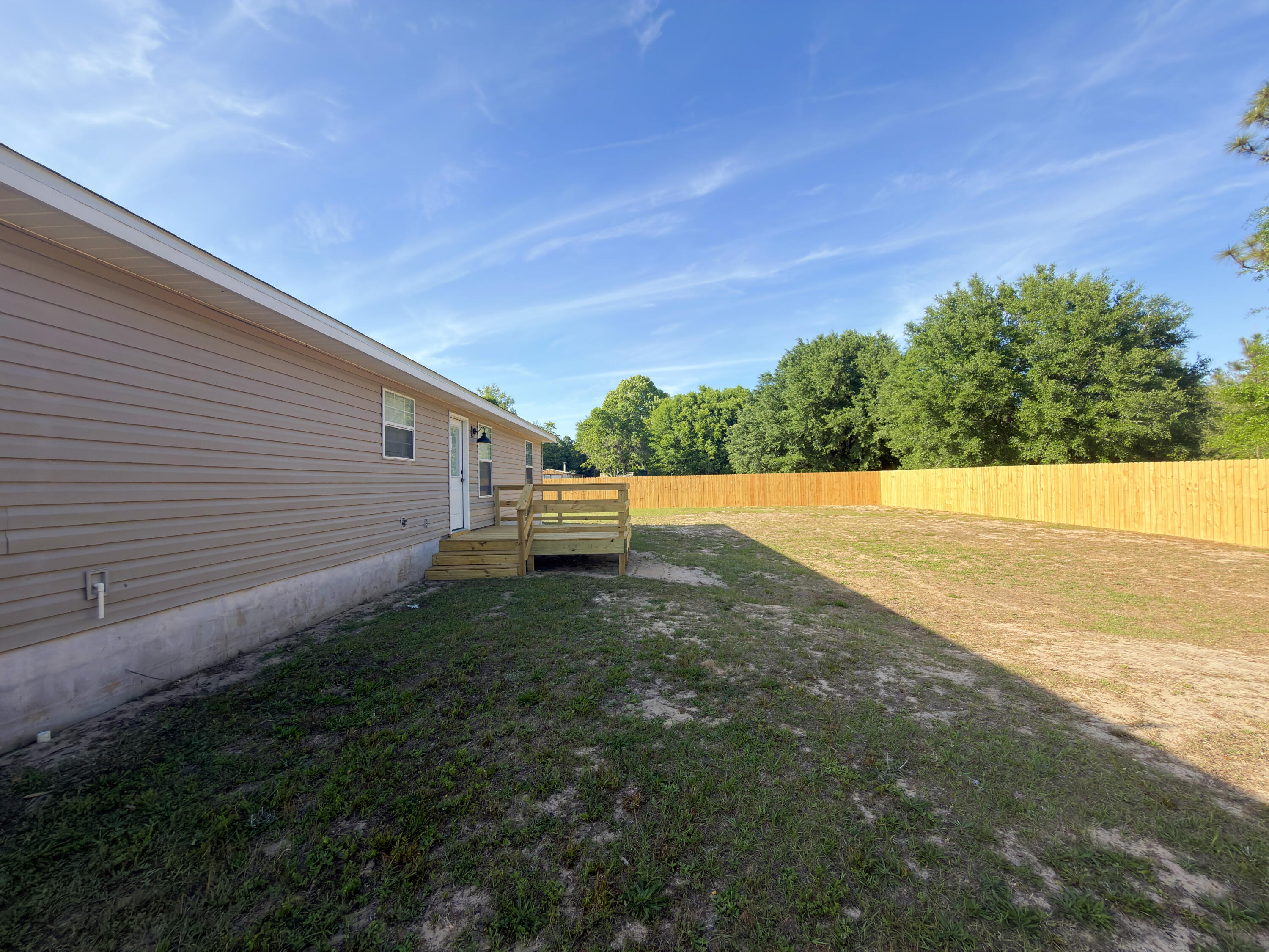 6121 Robin Road Crestview, FL 32539 - Photo 26 of 26 a backyard of a house with lots of green space