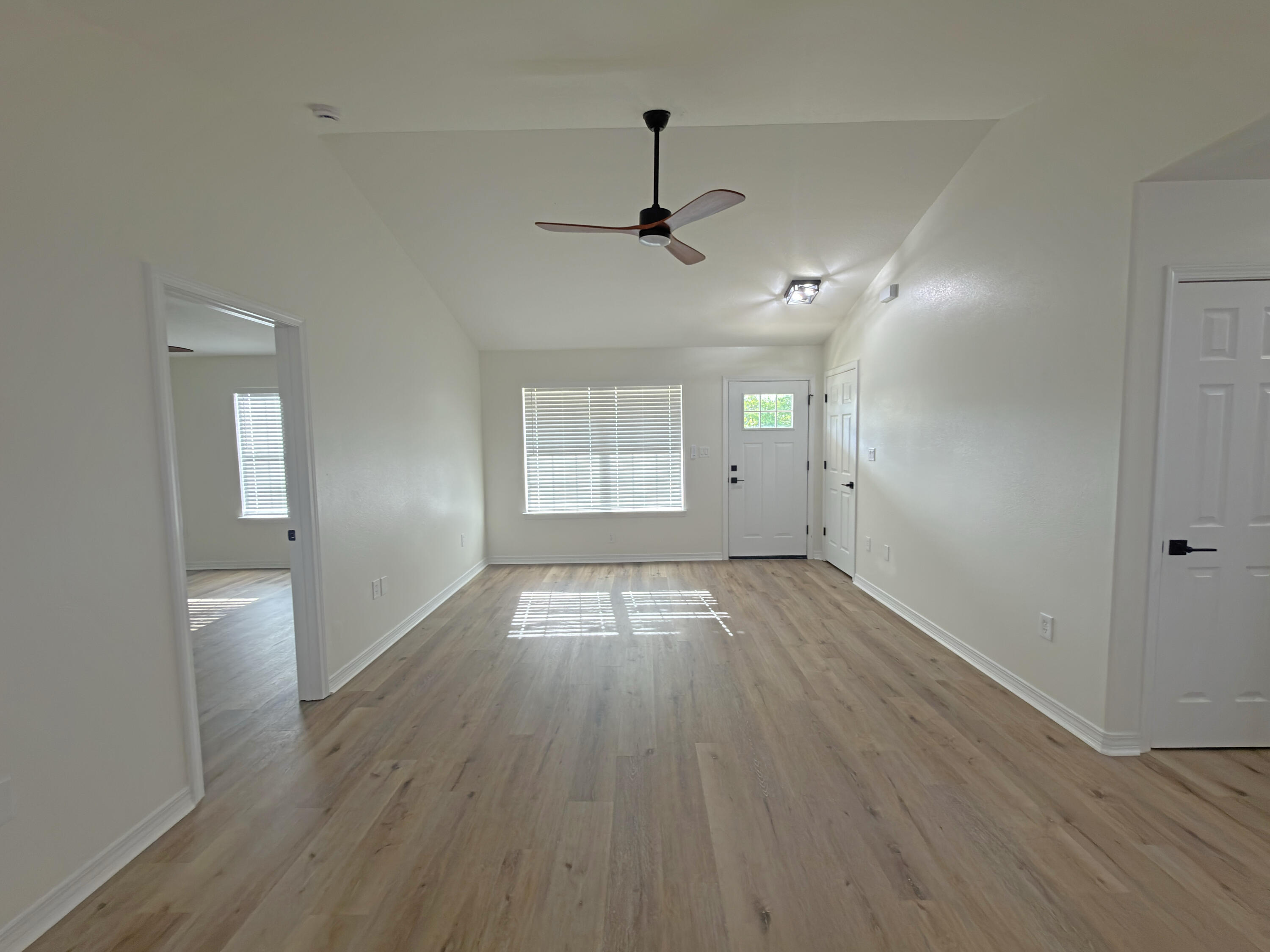 6121 Robin Road Crestview, FL 32539 - Photo 3 of 26 a view of empty room with wooden floor and fan