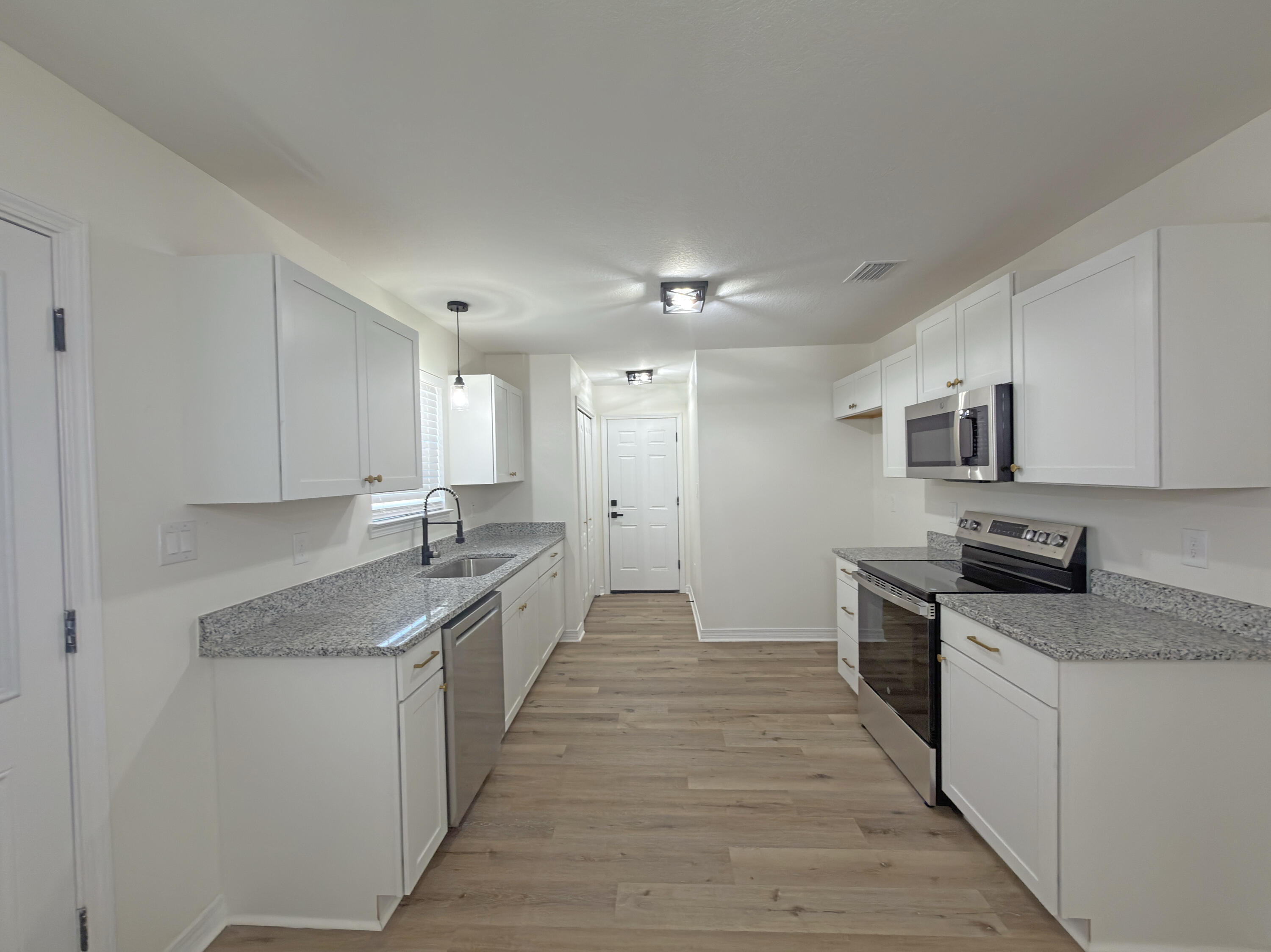 6121 Robin Road Crestview, FL 32539 - Photo 6 of 26 a large kitchen with cabinets stainless steel appliances a sink and a counter top space