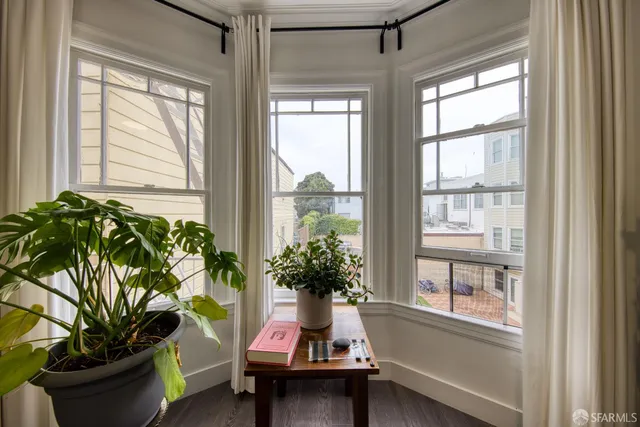a living room with furniture and a potted plant