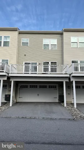 a view of a chairs and table on the balcony