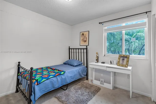 a bedroom with a bed and a desk