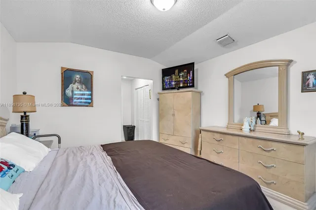 a bedroom with a bed and a desk