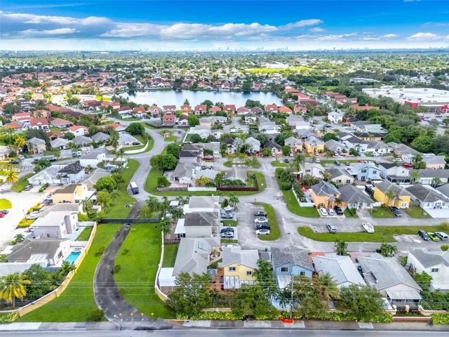 an aerial view of residential houses with outdoor space