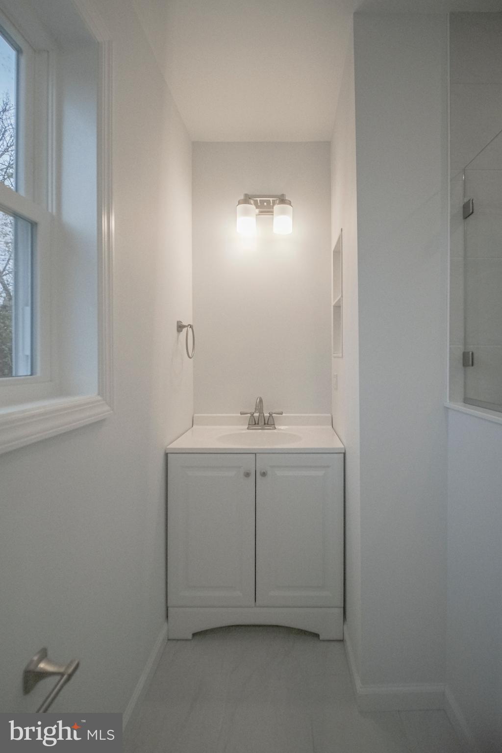 125 North Shore Road Marmora, NJ 08223 - Photo 17 of 26 a bathroom with a sink and vanity
