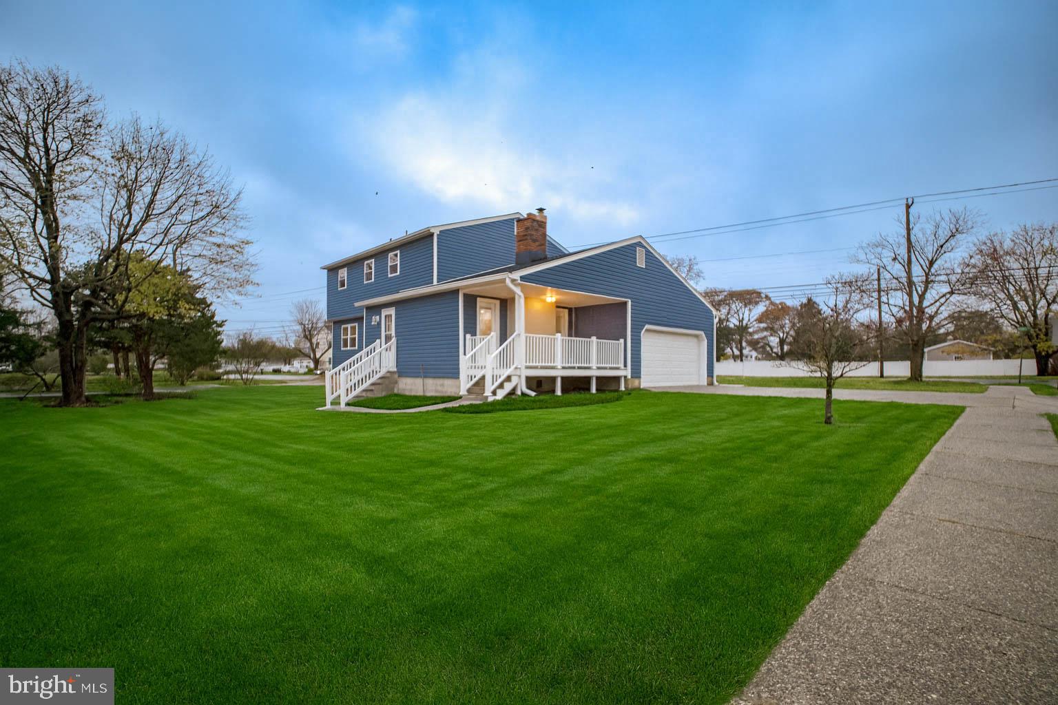 125 North Shore Road Marmora, NJ 08223 - Photo 3 of 26 a front view of house with yard and green space