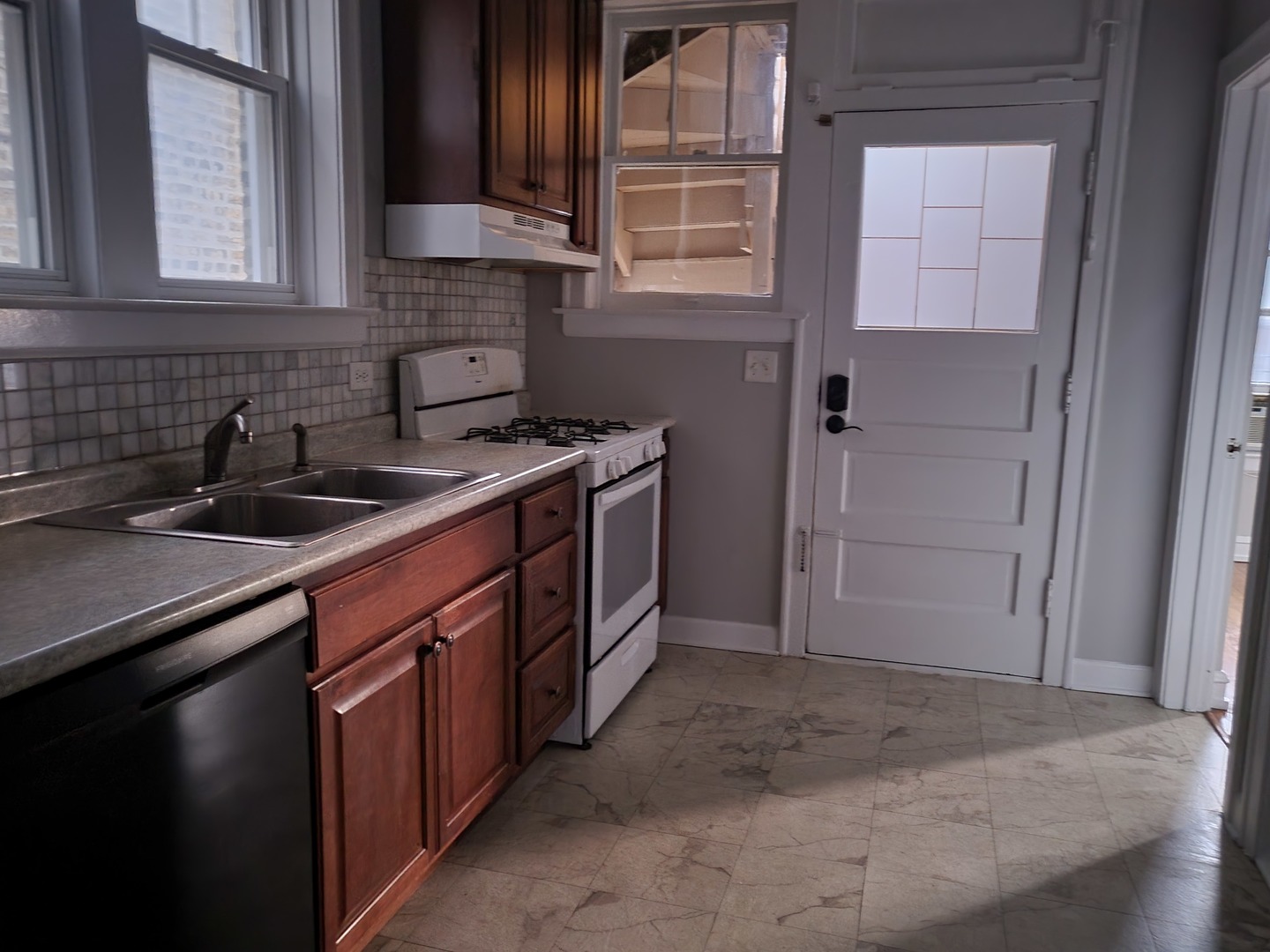 4831 Lee Street Skokie, IL 60077 - Photo 3 of 12 a kitchen with a sink stove and cabinets