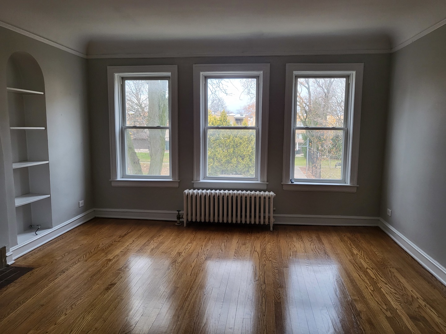 4831 Lee Street Skokie, IL 60077 - Photo 5 of 12 an empty room with wooden floor and windows