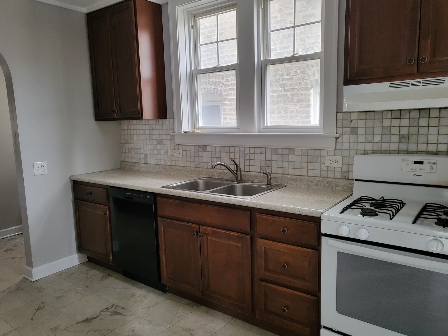 4831 Lee Street Skokie, IL 60077 - Photo 8 of 12 a kitchen with sink cabinets and window
