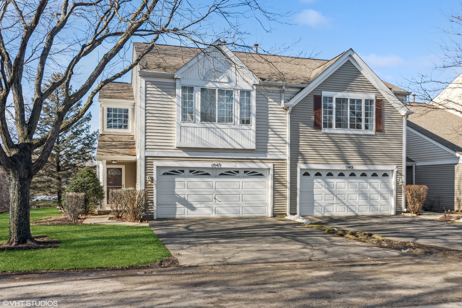 1545 Spaulding Road Bartlett, IL 60103 - Photo 1 of 21 a front view of a house with a yard and garage