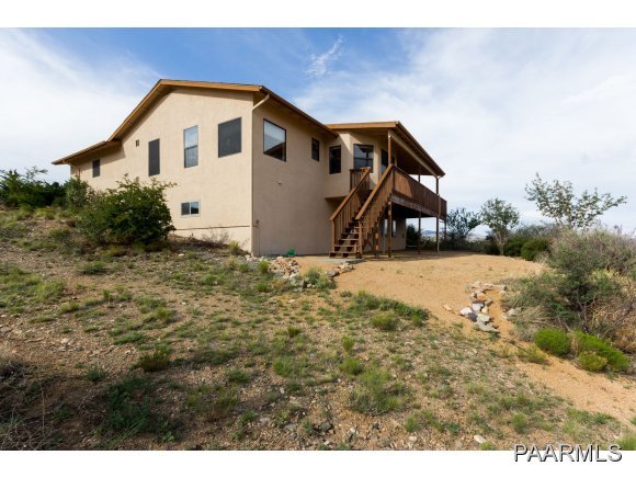 11801 Henderson Road Dewey-Humboldt, AZ 86327 - Photo 16 of 19 a view of a house with a yard