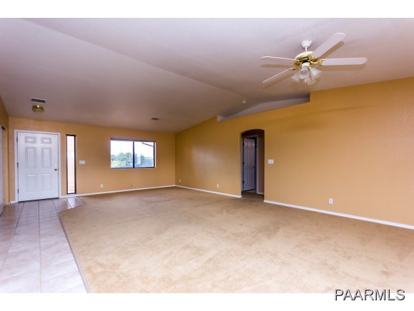 11801 Henderson Road Dewey-Humboldt, AZ 86327 - Photo 3 of 19 a view of a livingroom with a ceiling fan and window