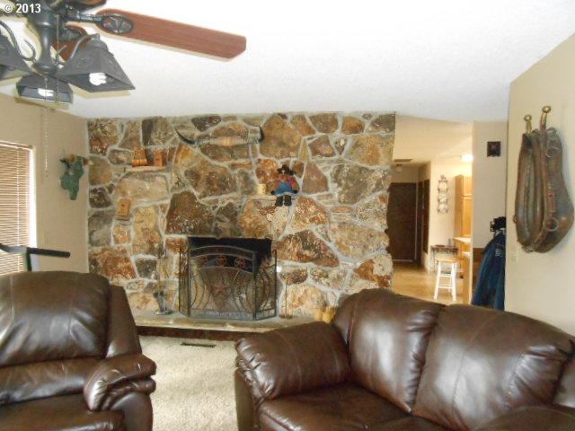 12015 South Fox Road Molalla, OR 97038 - Photo 3 of 16 a living room with furniture and a fireplace