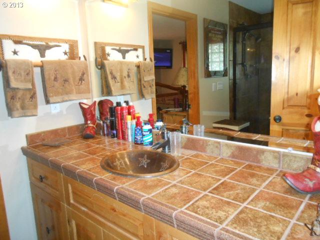 12015 South Fox Road Molalla, OR 97038 - Photo 7 of 16 a bathroom with a granite countertop sink and a mirror