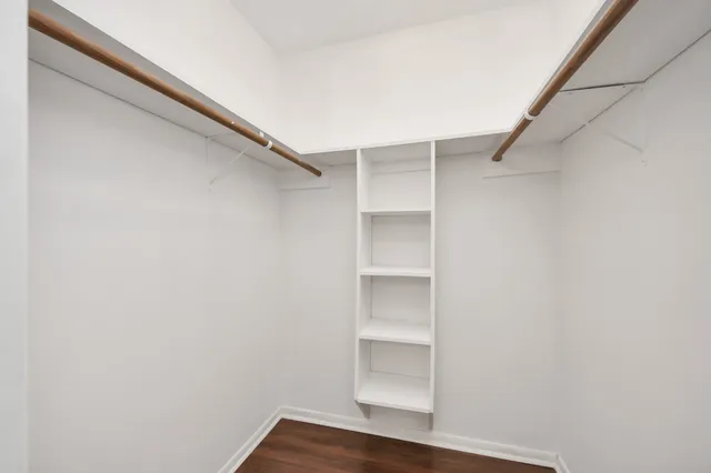 a view of walk in closet with empty racks