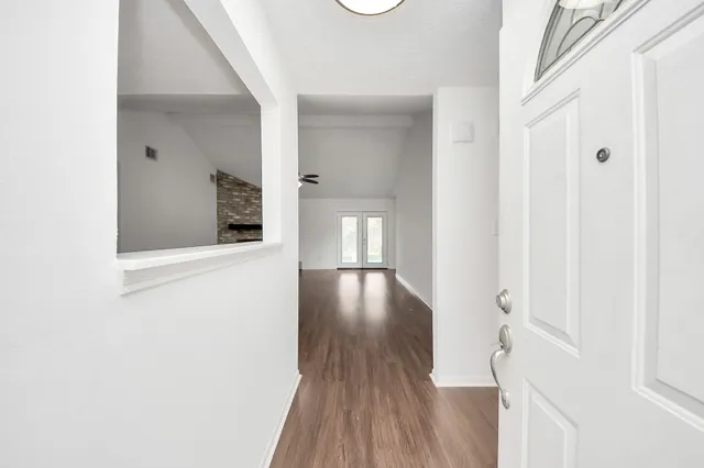 a view of a hallway with wooden floor and floors