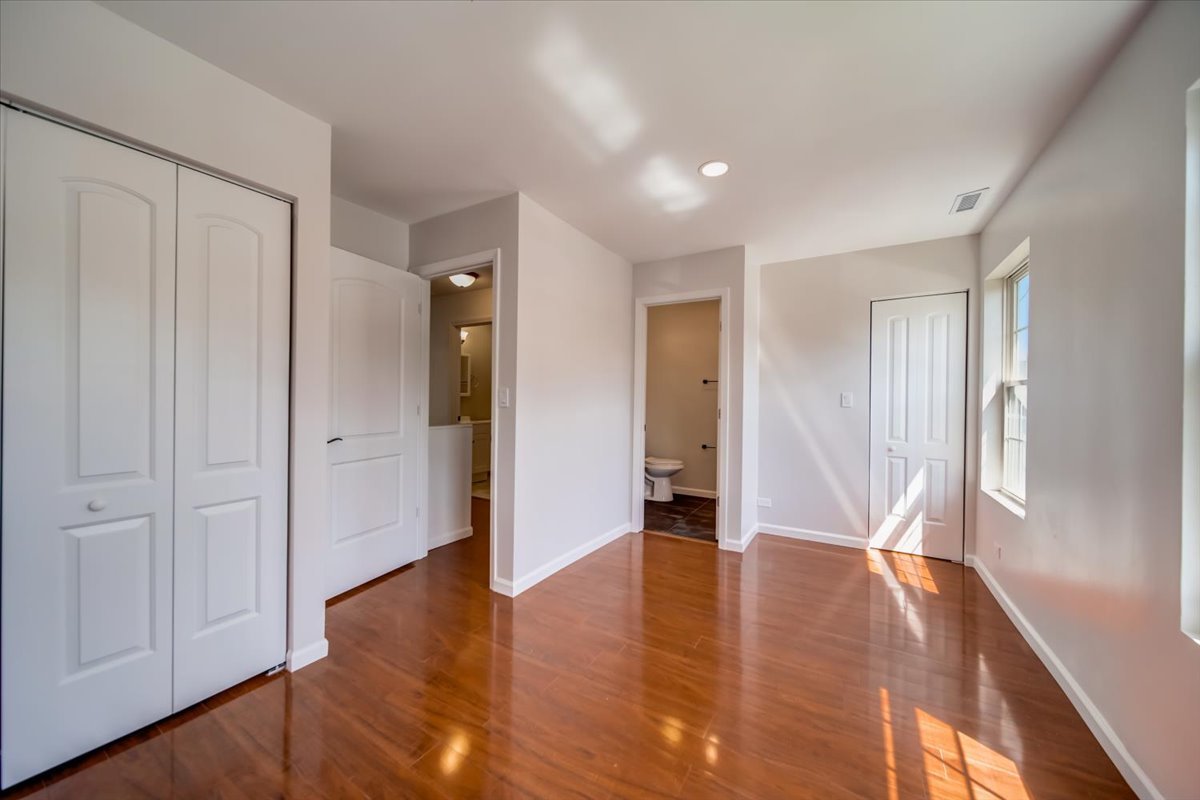 2414 West Harrison Street, Unit E Chicago, IL 60612 - Photo 12 of 37 a view of an empty room with wooden floor and closet area