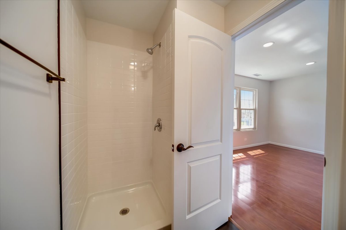 2414 West Harrison Street, Unit E Chicago, IL 60612 - Photo 16 of 37 a view of a hallway with wooden floor and a bathroom