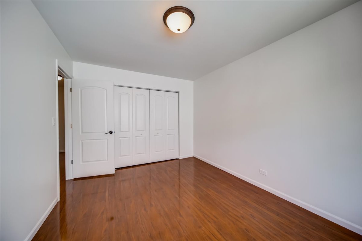 2414 West Harrison Street, Unit E Chicago, IL 60612 - Photo 19 of 37 a view of empty room with wooden floor